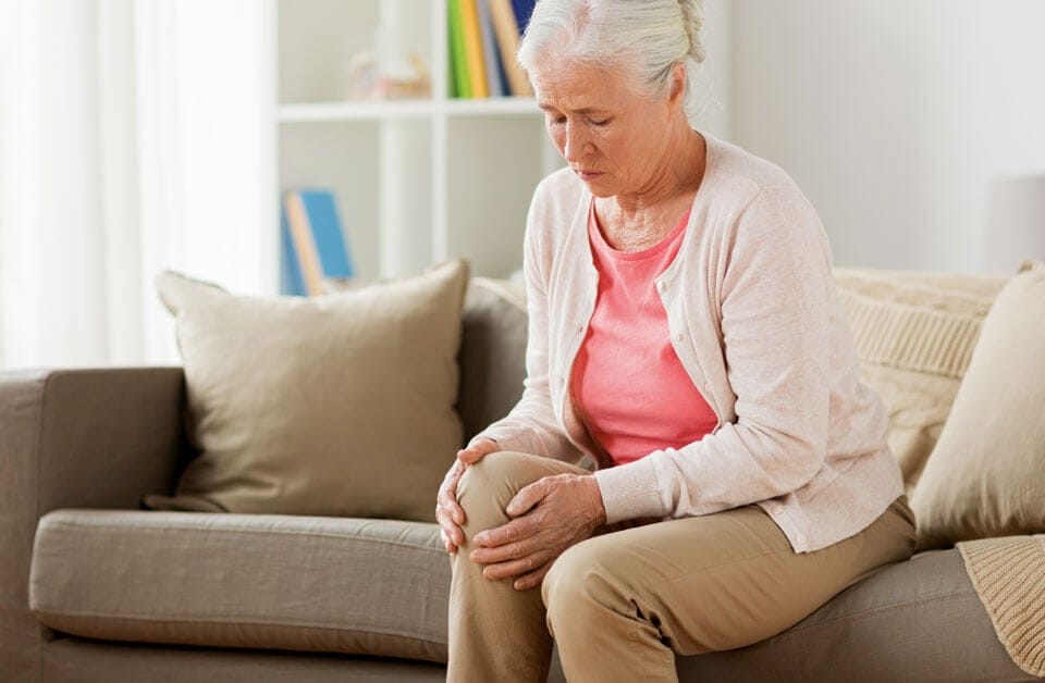 Woman holding knee