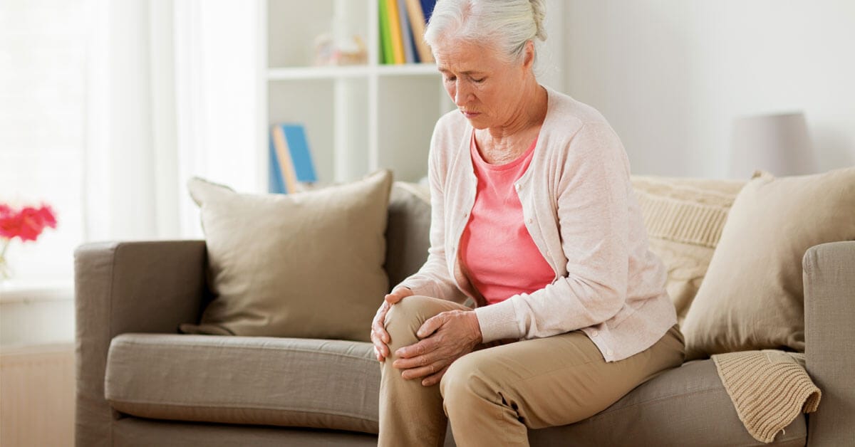 Woman holding knee