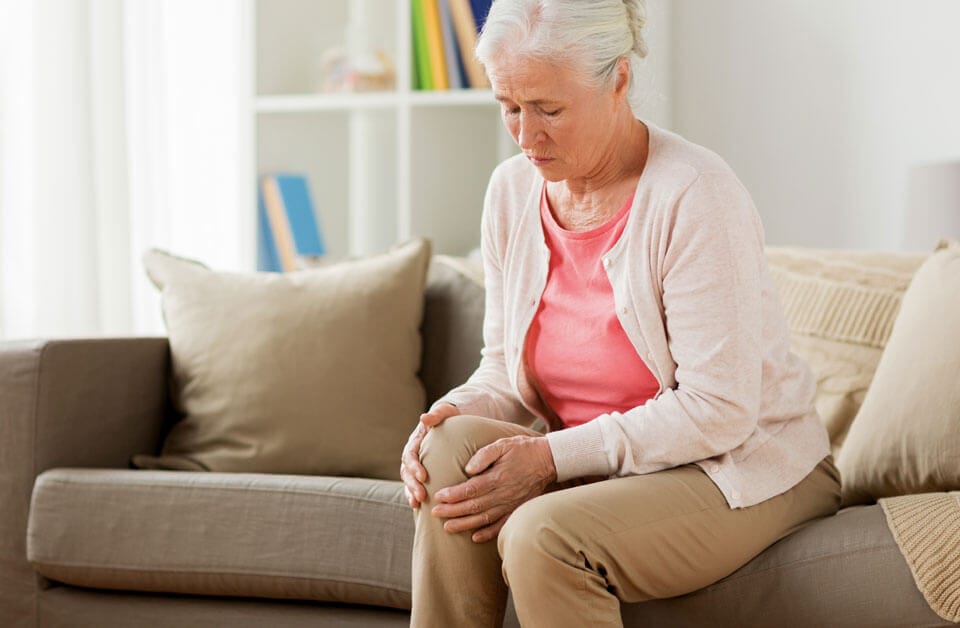 Woman holding knee