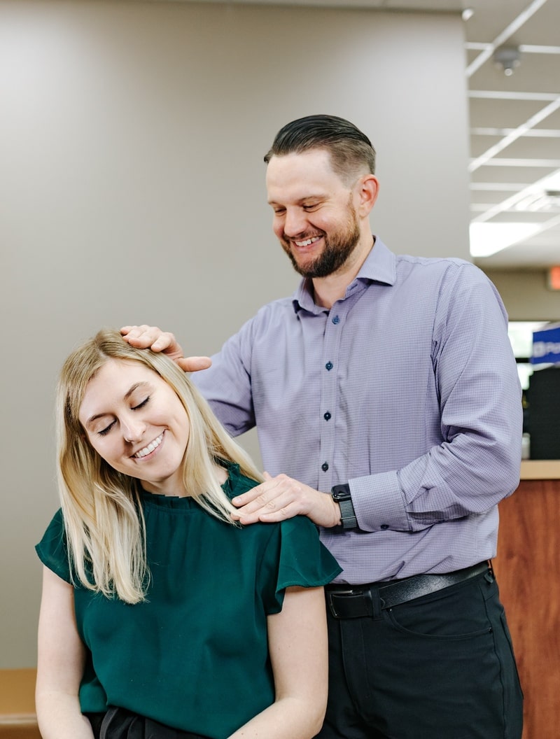 Doctor Giving Neck Adjustment for Sandstone Chiropractic